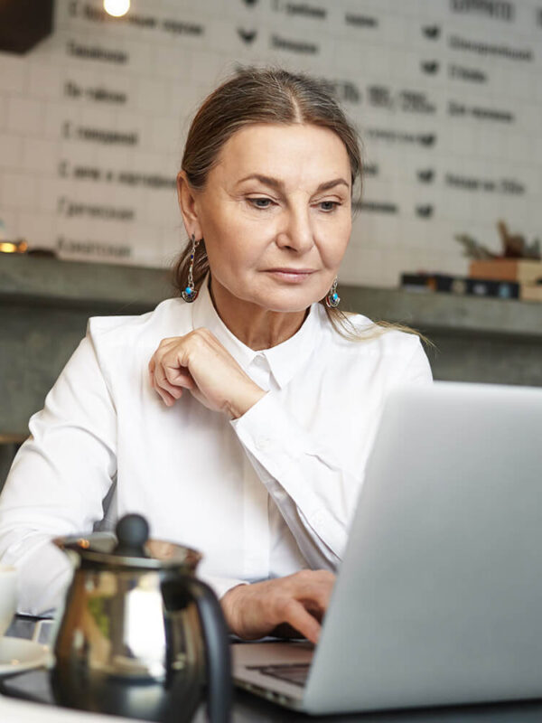 a girl sitting in front of laptop doing office work