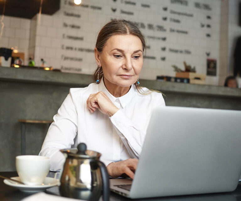 a girl sitting in front of laptop doing office work
