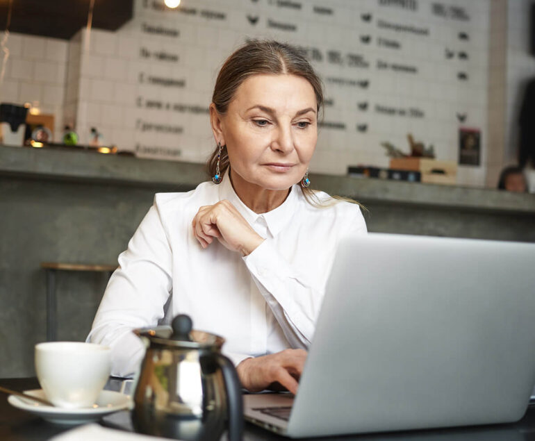 a girl sitting in front of laptop doing office work