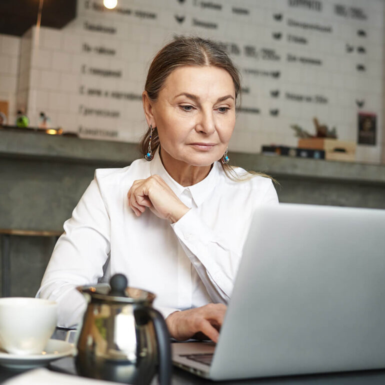 a girl sitting in front of laptop doing office work