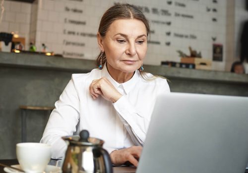 a girl sitting in front of laptop doing office work