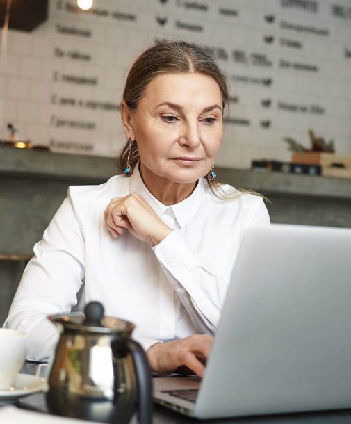 a girl sitting in front of laptop doing office work