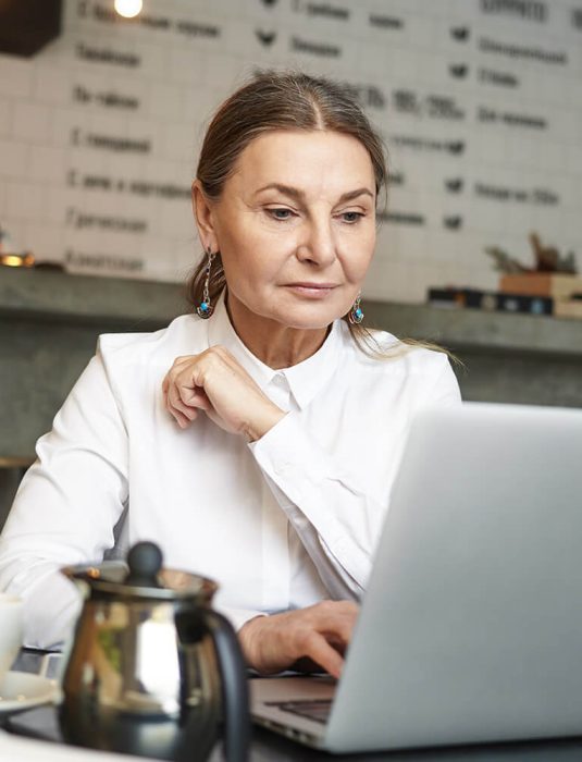 a girl sitting in front of laptop doing office work