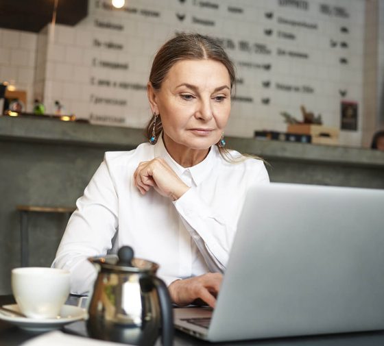 a girl sitting in front of laptop doing office work